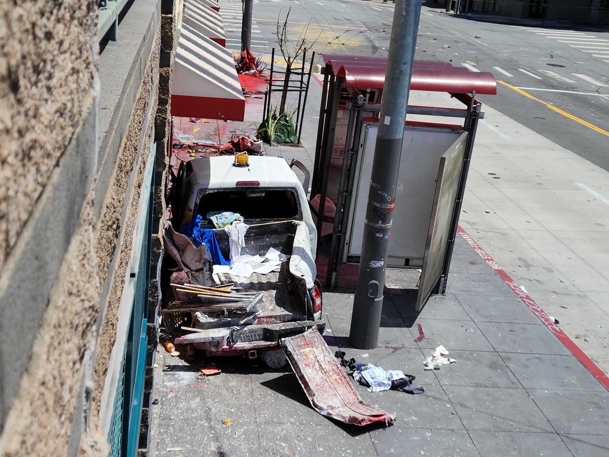 crashed pickup truck outside smashed bus stop, article for Proposition E