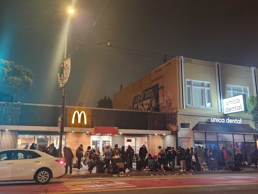 people congregating in front of a McDonalds store