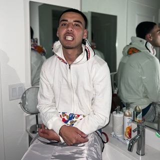 Javier Campos sitting on sink, smiling