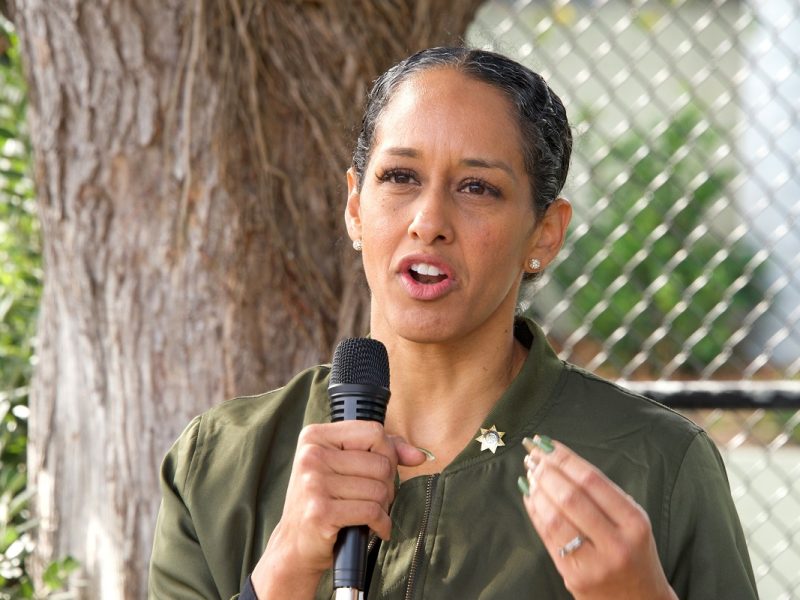 District Attorney Brooke Jenkins speaks into a microphone.