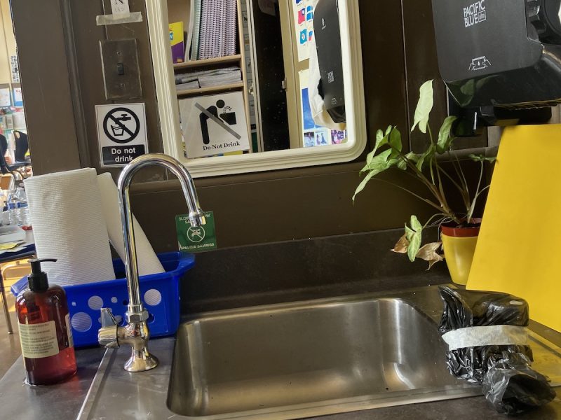 A sink with a plastic bag on it.