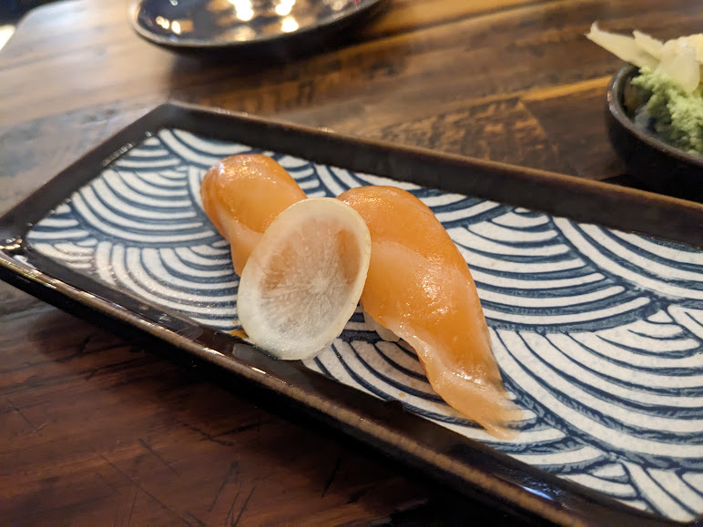Japanese sashimi on a blue and white plate.