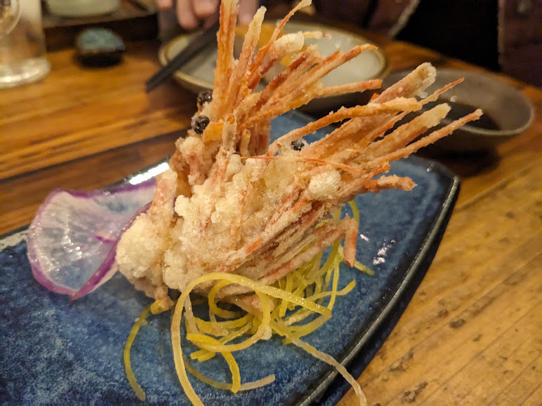 A plate of fried shrimp on a wooden table.