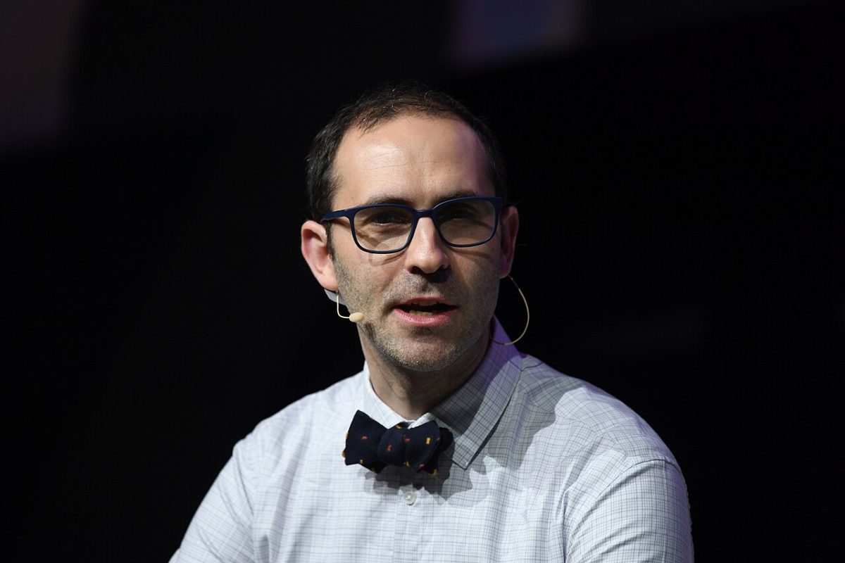 A man wearing glasses and a bow tie.