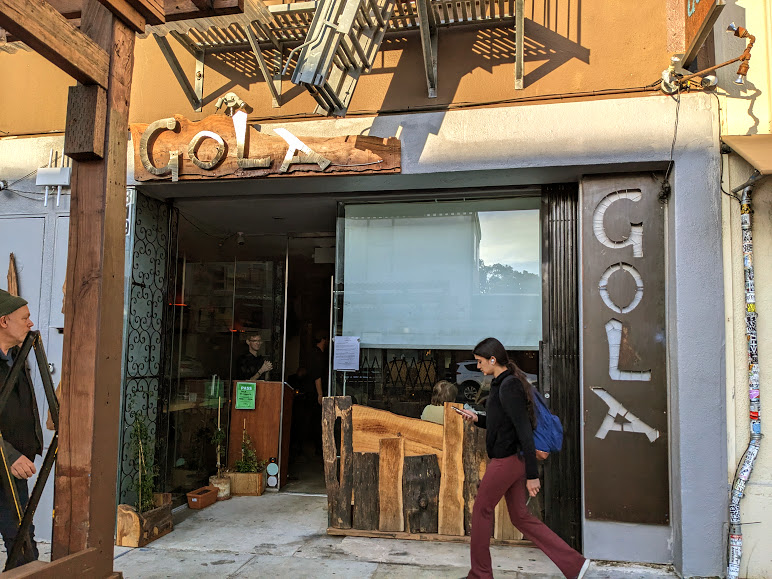 Passerby walking past the exterior or new Tunisian restaurant Gola. reclaimed wood and metal sheeting decorate the outside.