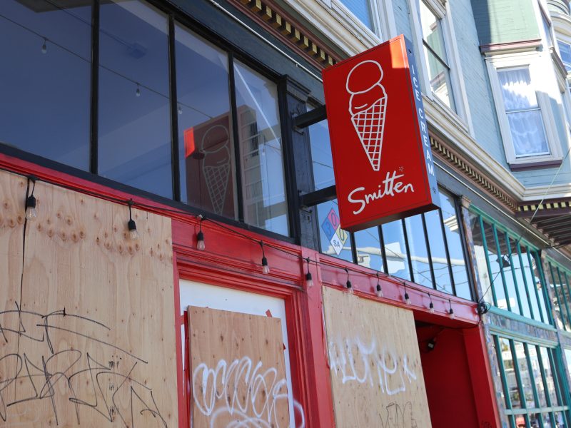 A boarded up storefront of an ice cream store.
