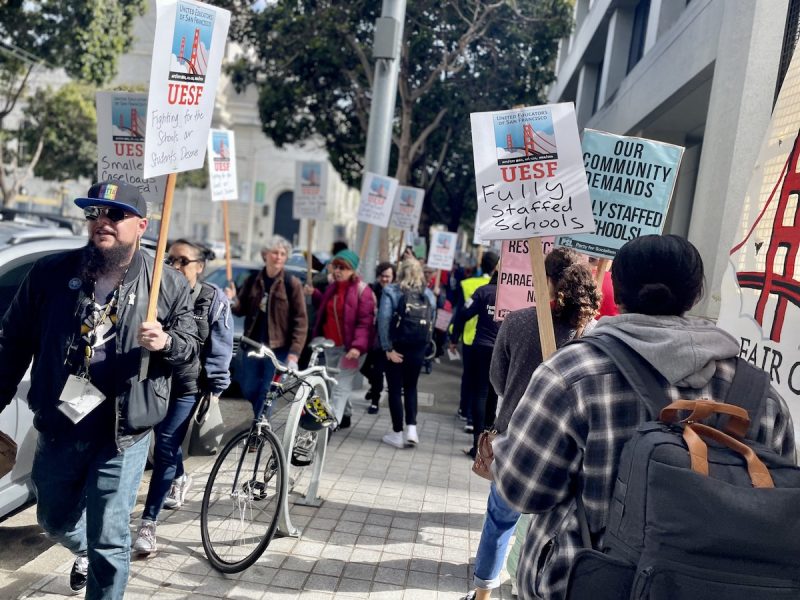 A group of people holding signs