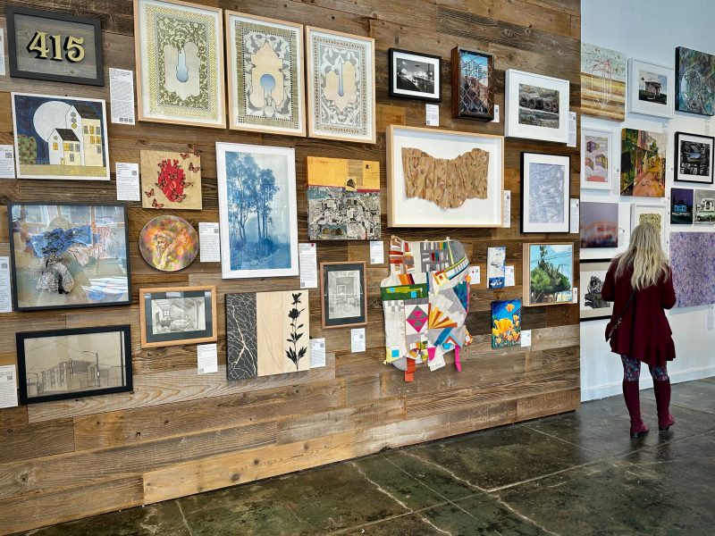 A woman looking at art in an art gallery.