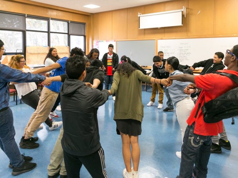 kids classroom holding hands