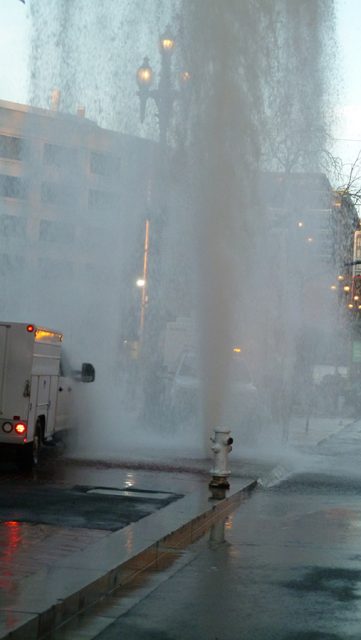 A fire hydrant spraying water.