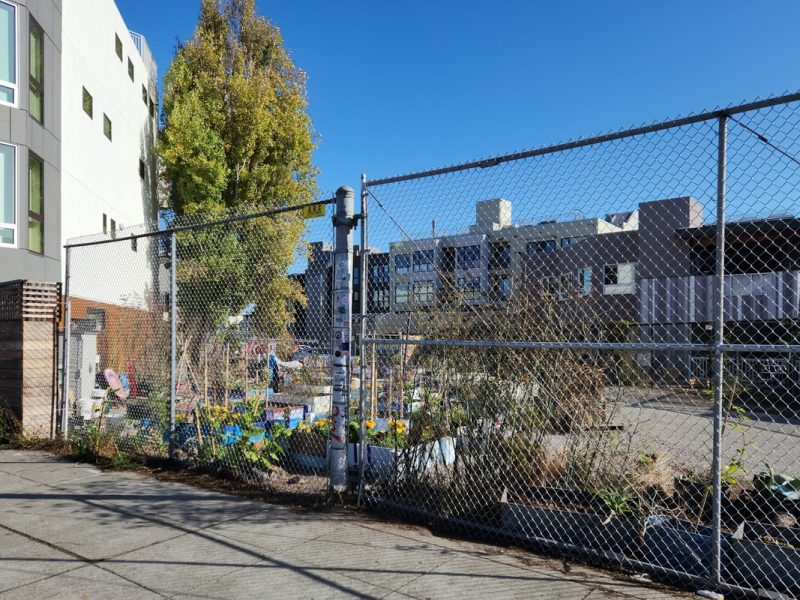 A chain link fence in front of Parcel 36