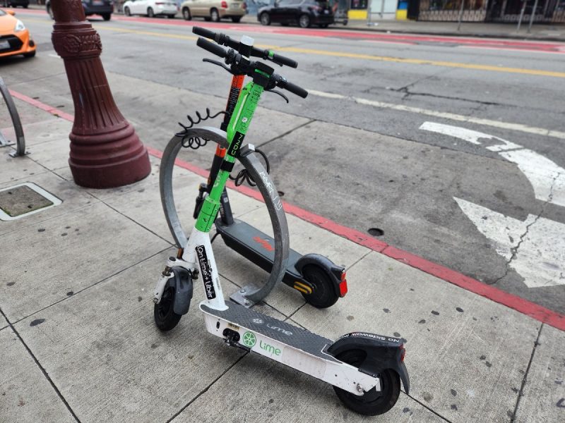 Lime and Spin scooters locked up on Mission Street.