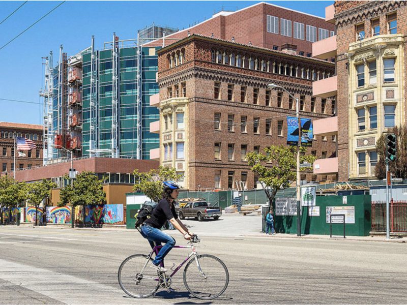 A bicyclist passes Zuckerberg San Francisco General Hospital.