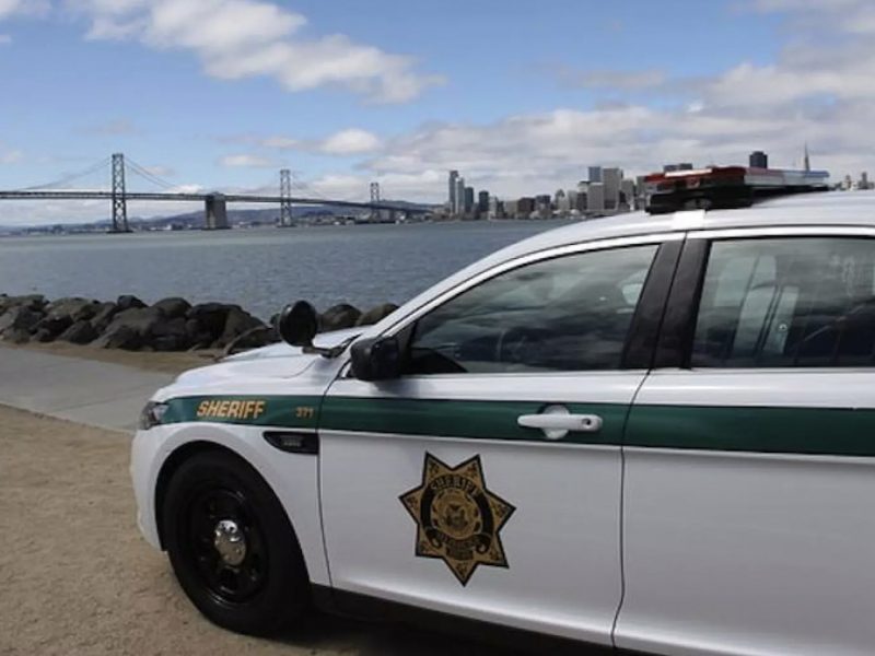 Sheriff's car parked with the bay and Bay Bridge in the background