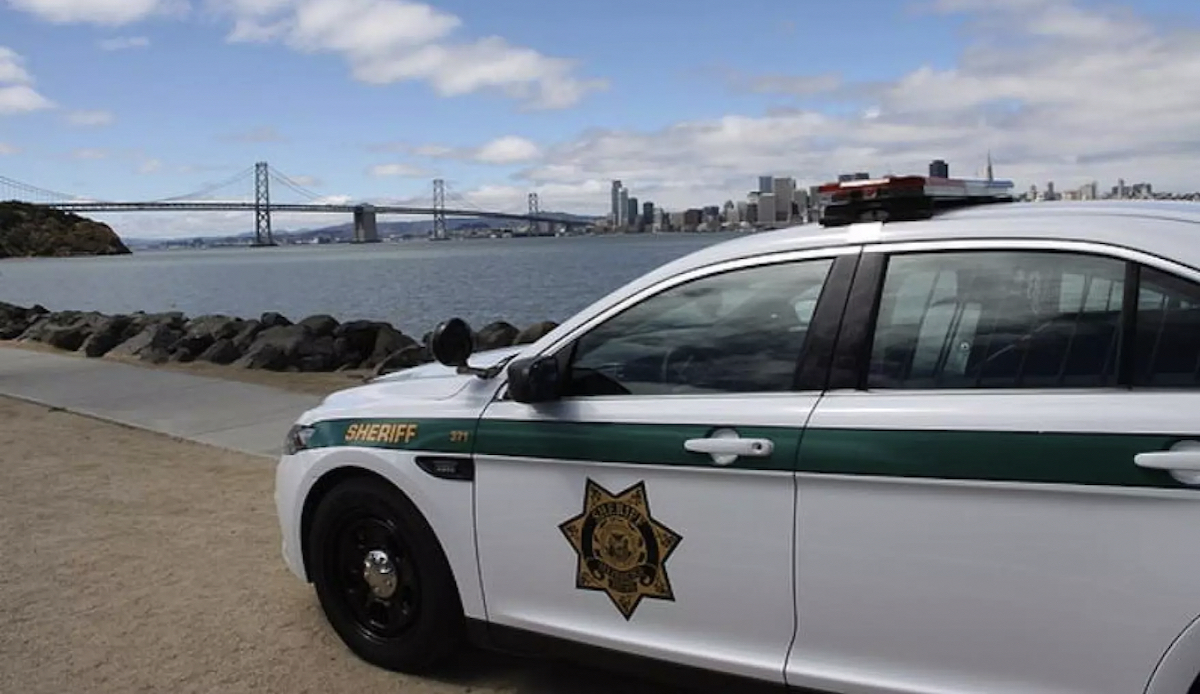 Sheriff's car parked with the bay and Bay Bridge in the background