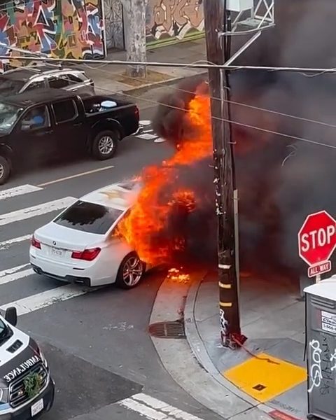 A car on fire on 24th and Hampshire streets in the Mission District
