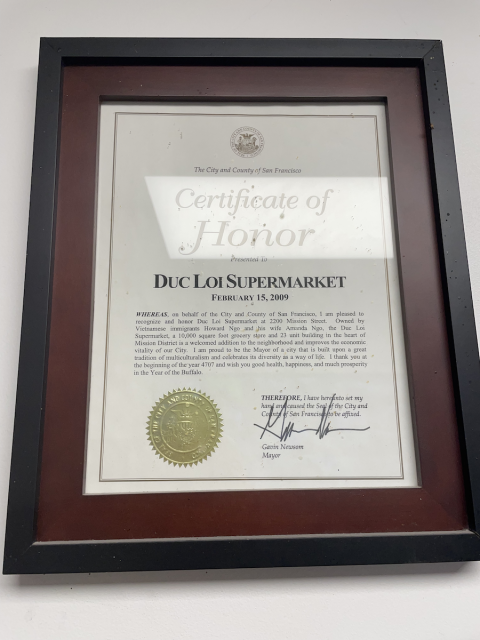 A framed certificate that says 'Certificate of Honor.' It's signed by Gavin Newsom.