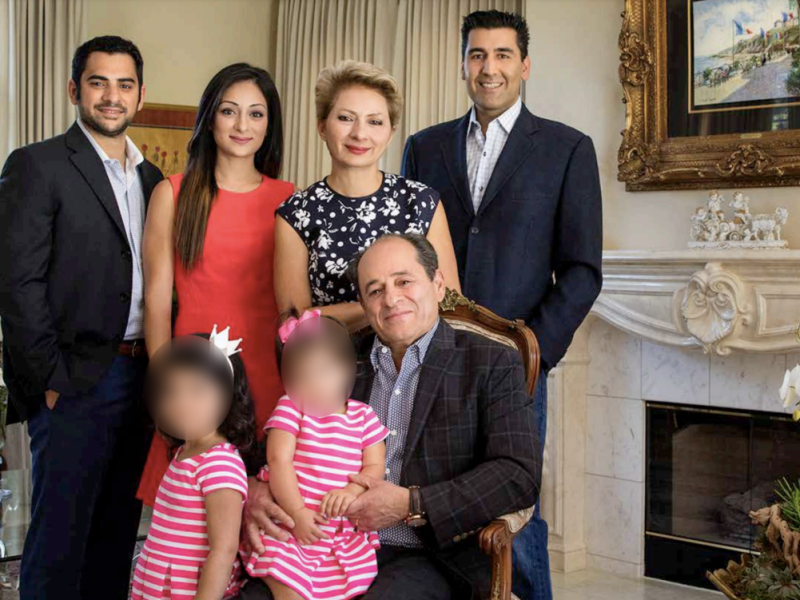 A family posing for a photo in a living room.